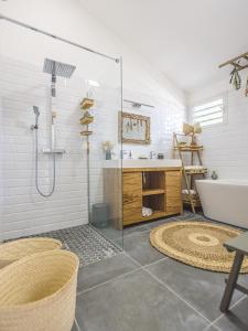 a bathroom with a shower and a sink and a tub at Ti Kaz Lontan - La Rivière in Saint-Louis