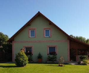 a house with a gambrel roof on a green yard at Slunečnice - Ubytování v soukromí na Třeboňsku in Třeboň