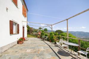 a balcony of a house with a table and chairs at Monolocale Fattorialmare Viola in Camogli