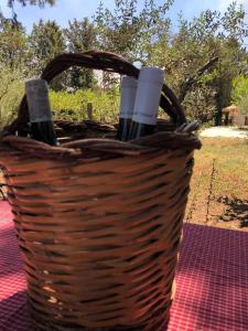 a basket of wine bottles sitting on a table at Cosi Priziusi in Vizzini