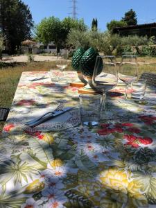 a table with a colorful table cloth with wine glasses at Cosi Priziusi in Vizzini