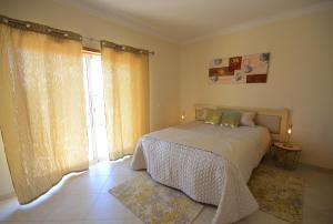 a bedroom with a bed and a large window at Casa Da Torre Espetacular V4 Com Piscina in Portimão +16 photos