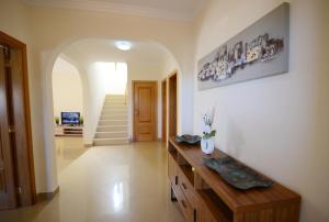 a living room with a wooden table and a staircase at Casa Da Torre Espetacular V4 Com Piscina in Portimão