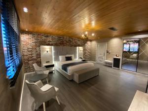 a bedroom with a bed and a brick wall at Elifim Resort Hotel in Bolu