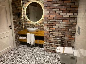 a bathroom with a sink and a brick wall at Elifim Resort Hotel in Bolu