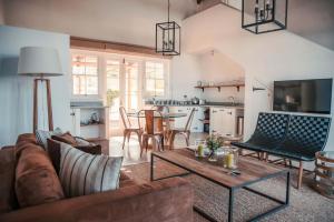 a living room with a couch and a table at Penhill Farm West Grange in Nuy