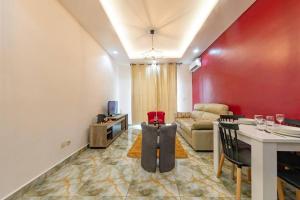 a living room with a table and a couch at Douala-Bonapriso: Superbe Appartement in Douala