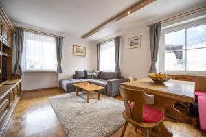 a living room with a couch and a table at Apartments Stua da Carlo in Ortisei