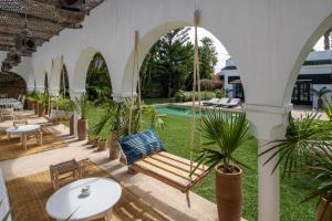 an outdoor patio with a swing and a pool at Maison Marine in Oualidia