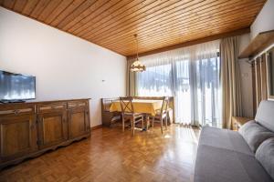 a living room with a table and a dining room at Apartments Praruf in Selva di Val Gardena