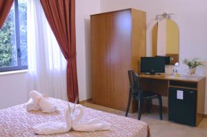 Postel nebo postele na pokoji v ubytování Desusino Residence & Hotel