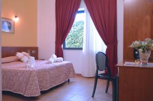 Postel nebo postele na pokoji v ubytování Desusino Residence & Hotel