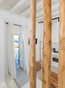 a kitchen with wooden columns in a house at Karai, The House Project in Astypalaia Town