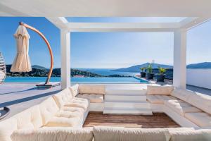 a living room with a white couch and a view of the ocean at Luxury Villa for 8 with 20m large Infinity Pool in Kalkan in Kaş