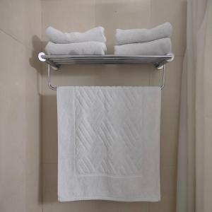 three towels on a rack in a bathroom at HOTEL AVN GRAND in Rānchī