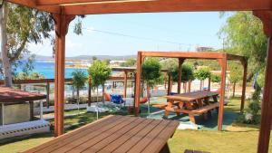 a patio with a picnic table and a gazebo at Akkum Beach Otel in Seferihisar