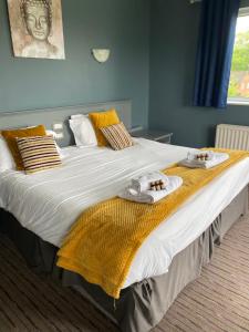 Una cama grande con toallas y toallas. en Bells Hotel en Coleford