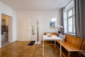 a living room with a white table and a bench at Große Altstadtwohnung in TOP Lage Zentrum in Dresden