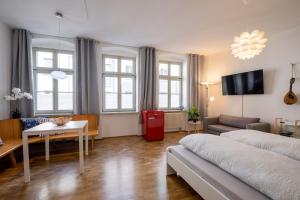 a living room with a couch and a table at Große Altstadtwohnung in TOP Lage Zentrum in Dresden