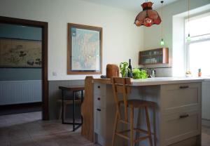 a kitchen with a counter and a bar with stools at The Presbytery, Forres in Forres