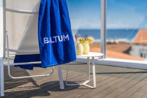 a blue towel sitting on a chair on a balcony at Hotel Baltum in Albufeira
