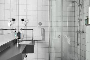 a bathroom with a shower and a sink at Comfort Hotel Børsparken in Oslo