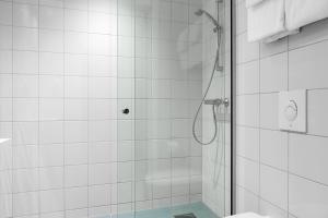 a bathroom with a shower with a glass door at Comfort Hotel Børsparken in Oslo