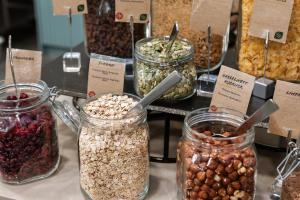 a display of jars of nuts and seeds on a table at Comfort Hotel Børsparken in Oslo