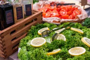 a display of vegetables with lemon slices and lettuce at Comfort Hotel Børsparken in Oslo