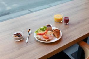 a plate of food on a table with a plate of food at Comfort Hotel Børsparken in Oslo