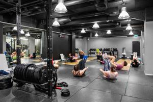 a group of people doing yoga in a gym at Comfort Hotel Børsparken in Oslo