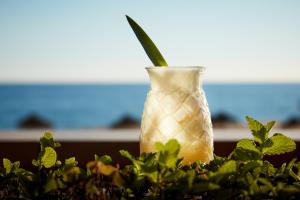 a glass vase filled with a green plant at Dom Jose Beach Hotel (Plus) in Quarteira
