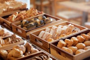 a display of different types of breads and pastries at Dom Jose Beach Hotel (Plus) in Quarteira