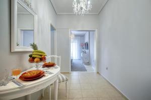 a kitchen with a table with a bowl of fruit on it at Luxury Apartment Zeas Piraeus in Piraeus