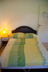 1 cama con edredón amarillo y verde en un dormitorio en Oaza Mira Vrdnik, en Vrdnik