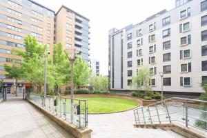 a walkway in a city with tall buildings at Modern Spacious studio close to station in London