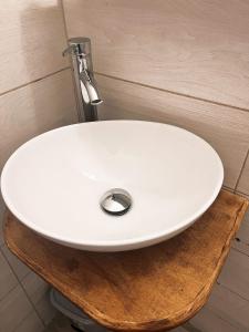 a white sink sitting on top of a wooden table at Nova Roma Guest House in Rome