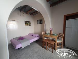 a bedroom with a bed and a table with a table at Sikinos Summer Nest in Síkinos