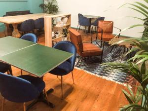 a room with chairs and a table and a table and chairs at Roamer St Kilda - formerly Selina St Kilda Melbourne in Melbourne