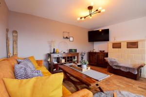 a living room with a couch and a table at Bungalow im Thüringer Wald/ Haus Selma in Suhl