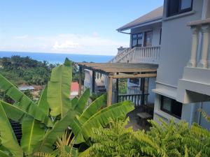 a balcony of a house with a view of the ocean at Island Cove in Victoria
