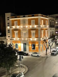 a large building with cars parked in front of it at ReLuxe Private Wellness in Lecce