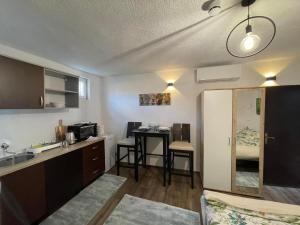 a small kitchen with a sink and a table at Montana Apartmani in Konjic