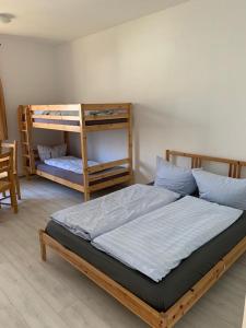 a bedroom with two bunk beds in a room at Tauchbasis Stechlin in Stechlin