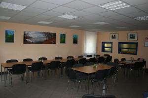 a conference room with tables and chairs in it at Tauchbasis Stechlin in Stechlin