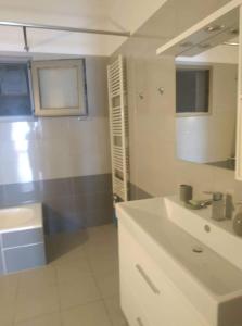 a bathroom with a white sink and a mirror at VIEW Apartment LUKOVE in Lukovë