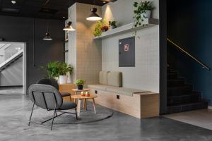 una sala de espera con una silla y una mesa en Comfort Hotel Xpress Youngstorget, en Oslo