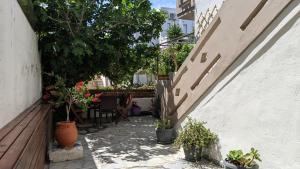 a patio with potted plants and a table and stairs at Pension Irene in Sougia