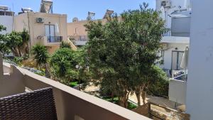 a balcony with a view of trees and buildings at Pension Irene in Sougia