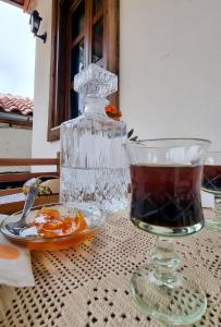 a glass bowl and a drink on a table at Arben Qemeri Guest House in Berat
